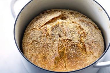 Baked bread in a round baking tin