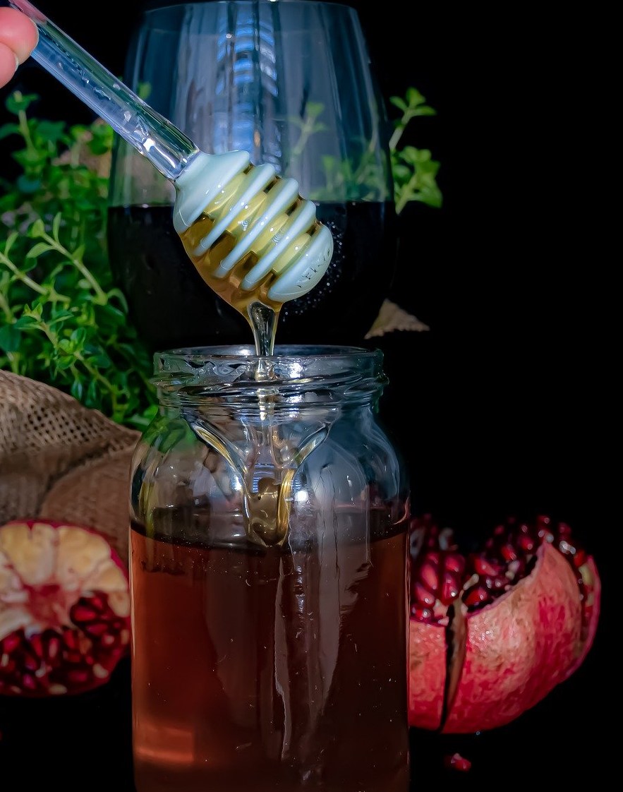 Jar of honey and pomegranates