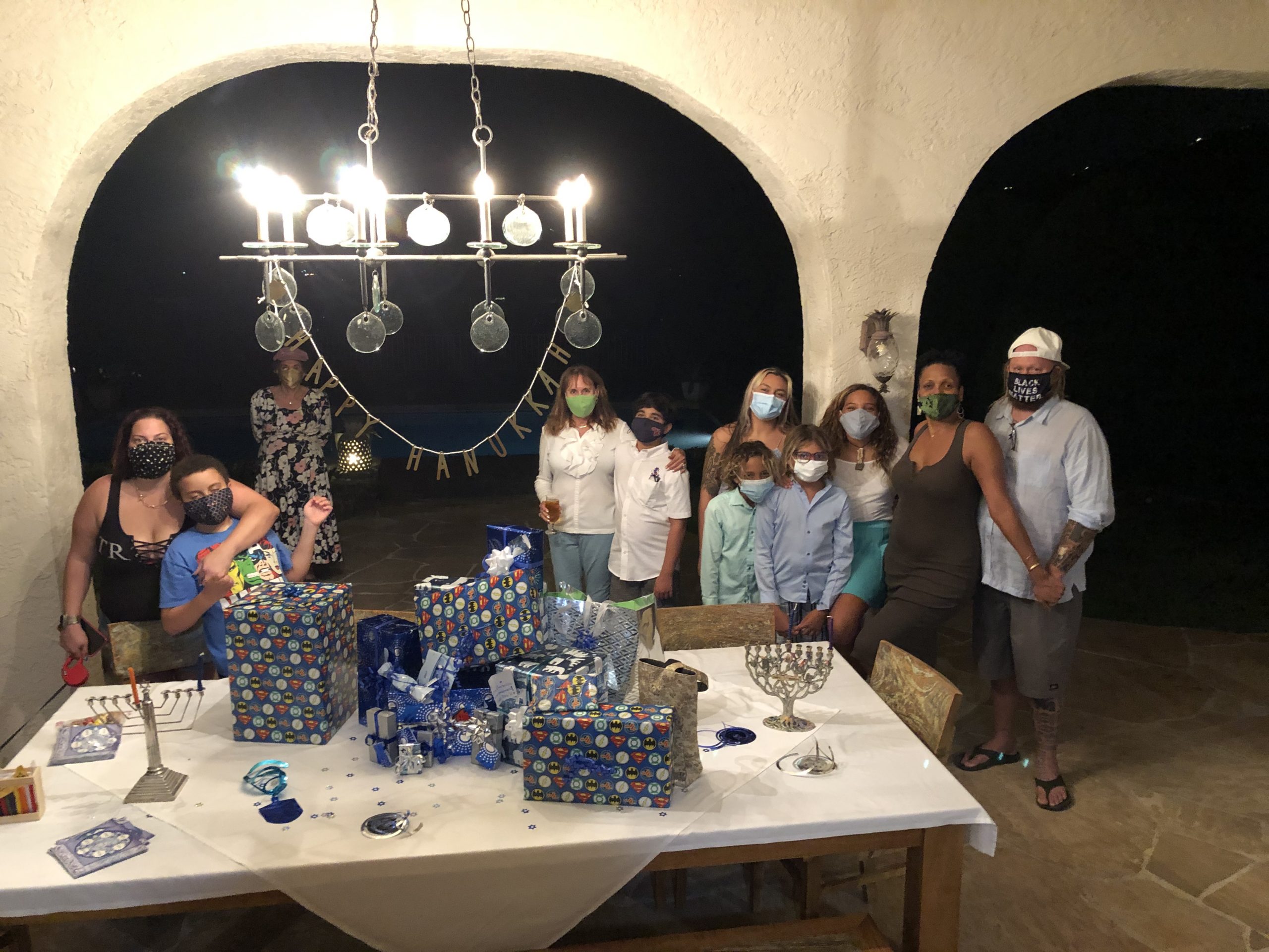 BY ROBERT LITTMAN Here is our COVID cautious Hanukkah. One daughter Tish with her family at one end. Other daughter Emma at the other and Bernice in the middle.